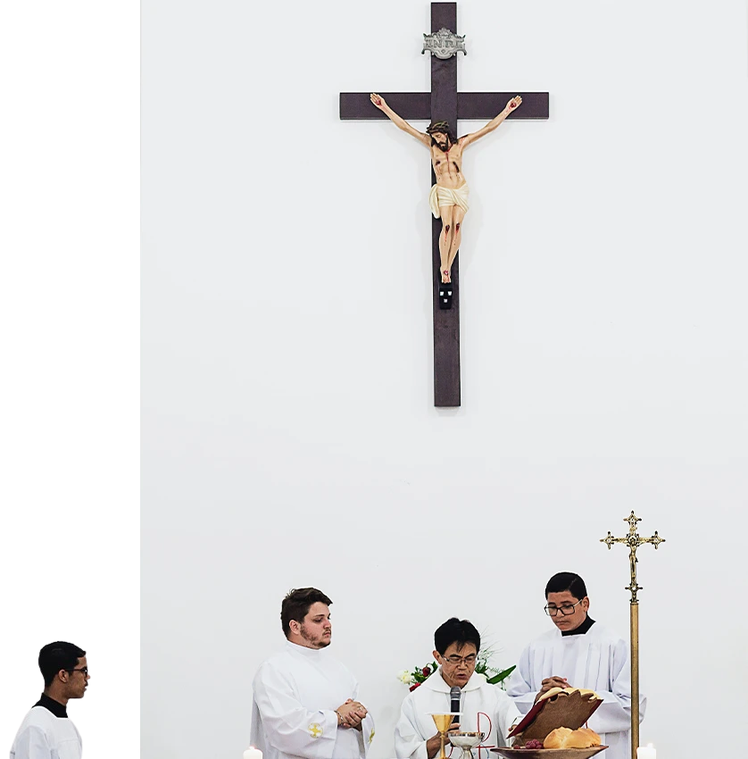 A group of men standing under a cross.