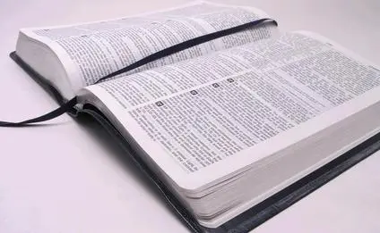 Open bible book with cloth book mark